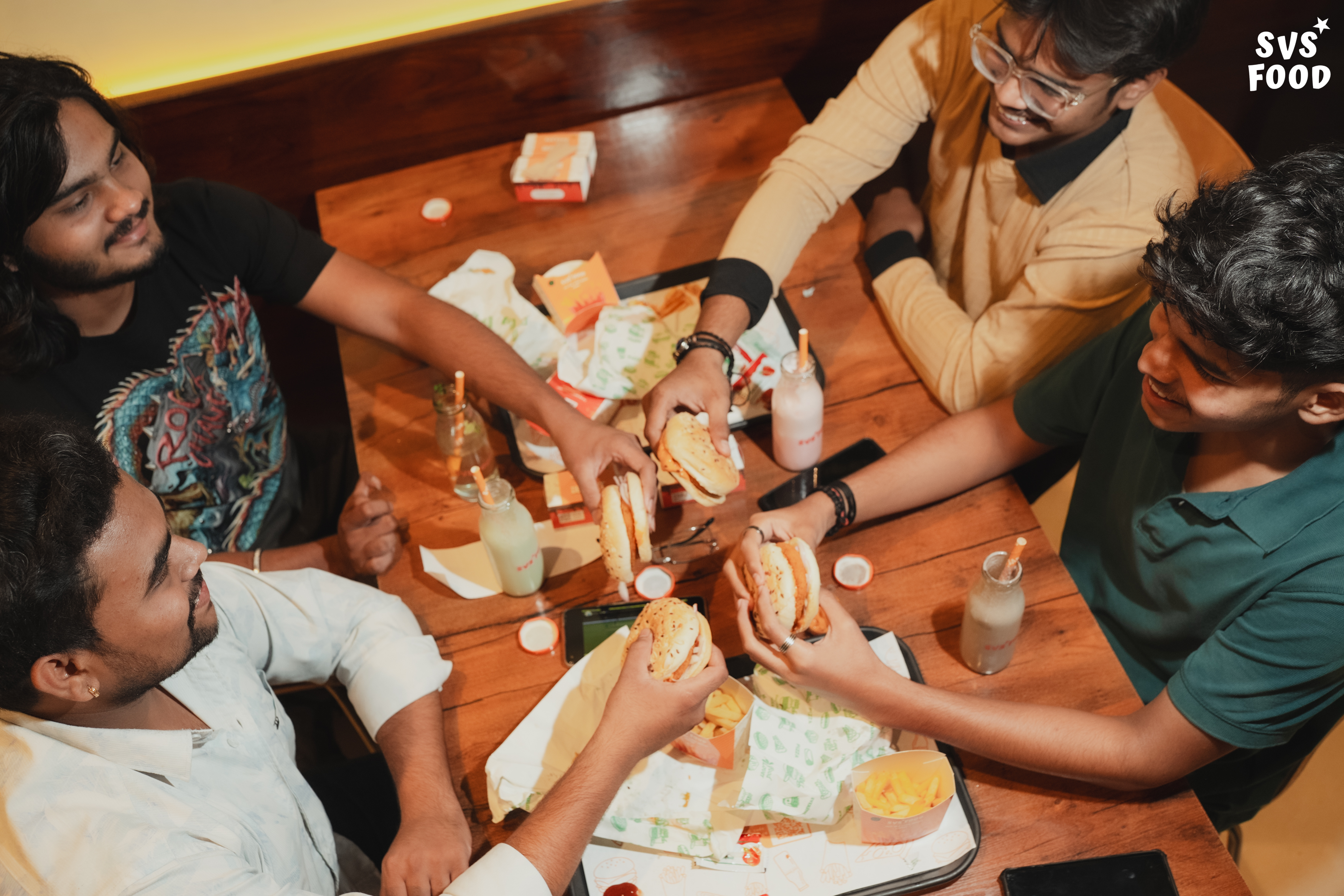 Friends celebrating with SVS Food burgers